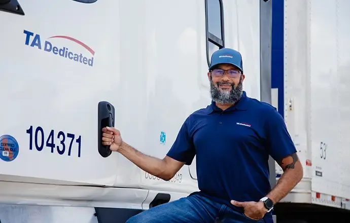 Dedicated driver standing next to truck