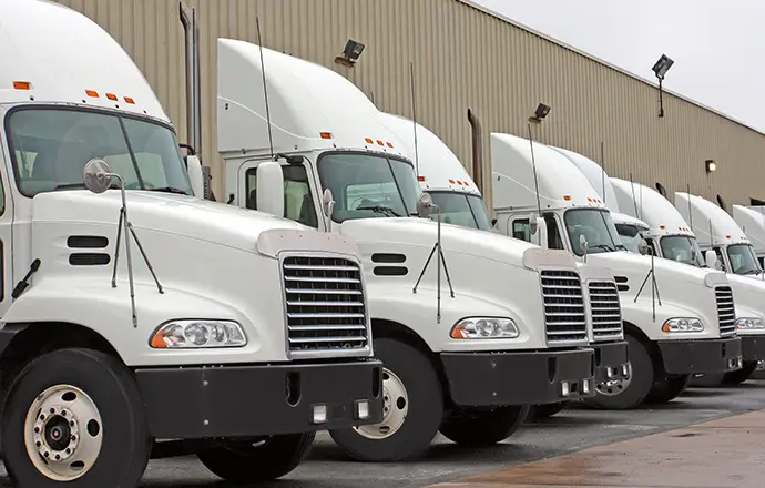 A dedicated fleet of trucks outside a terminal.