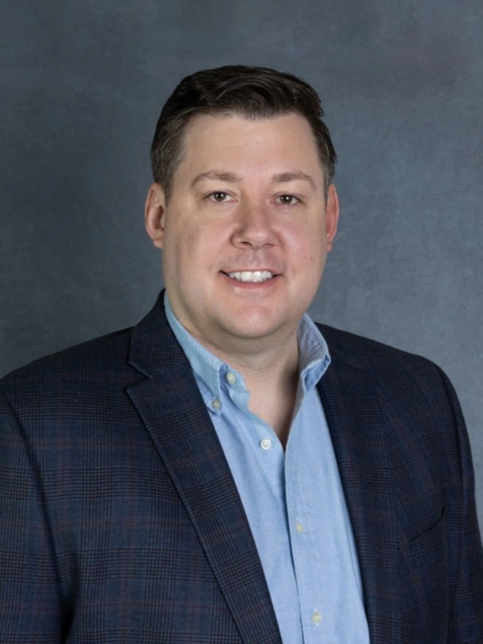 Russ Thorpe professional business headshot wearing blazer and dress shirt