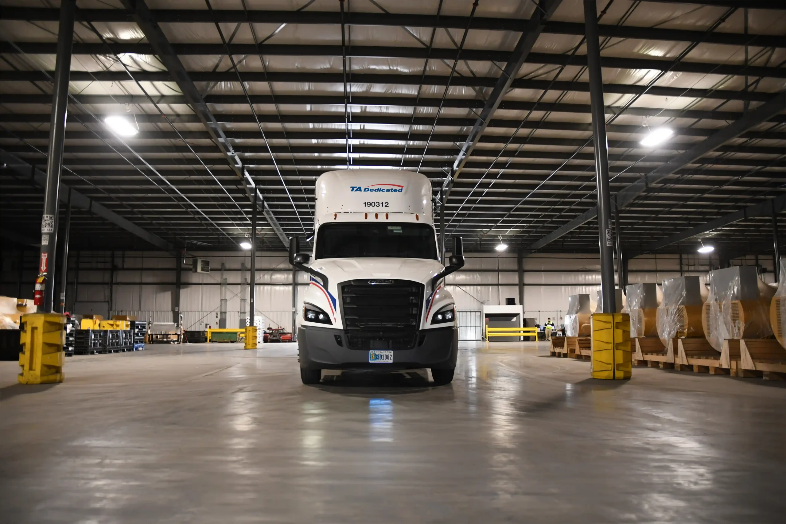 Front view of TA Dedicated truck leaving warehouse