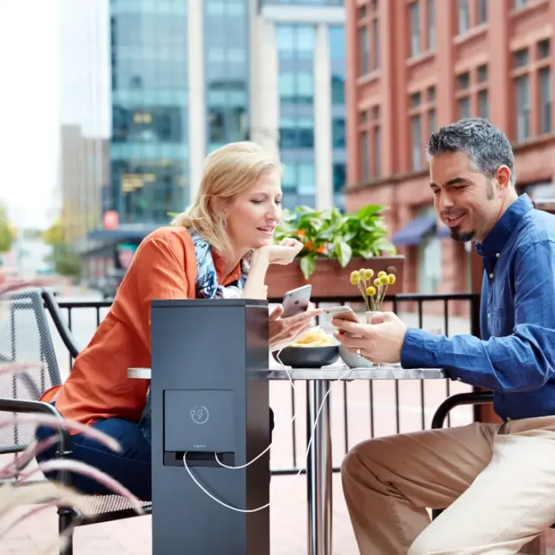 Two people sitting down looking at phone together